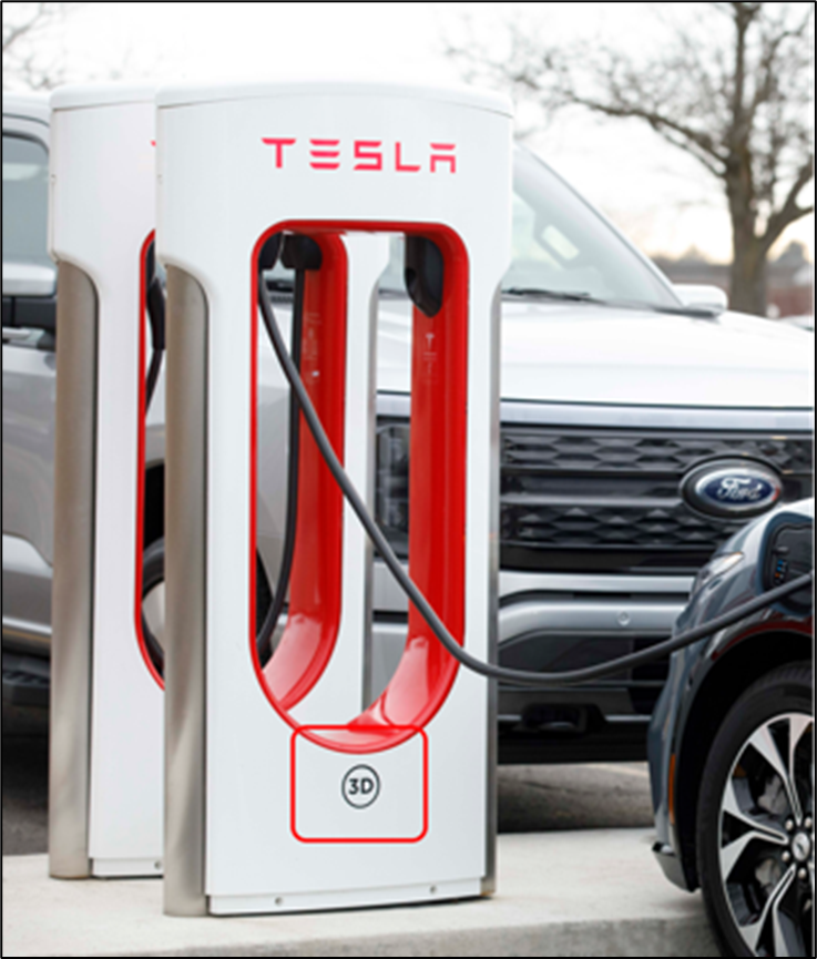 Photo of Tesla Superchargers. One is attached to a Ford vehicle.